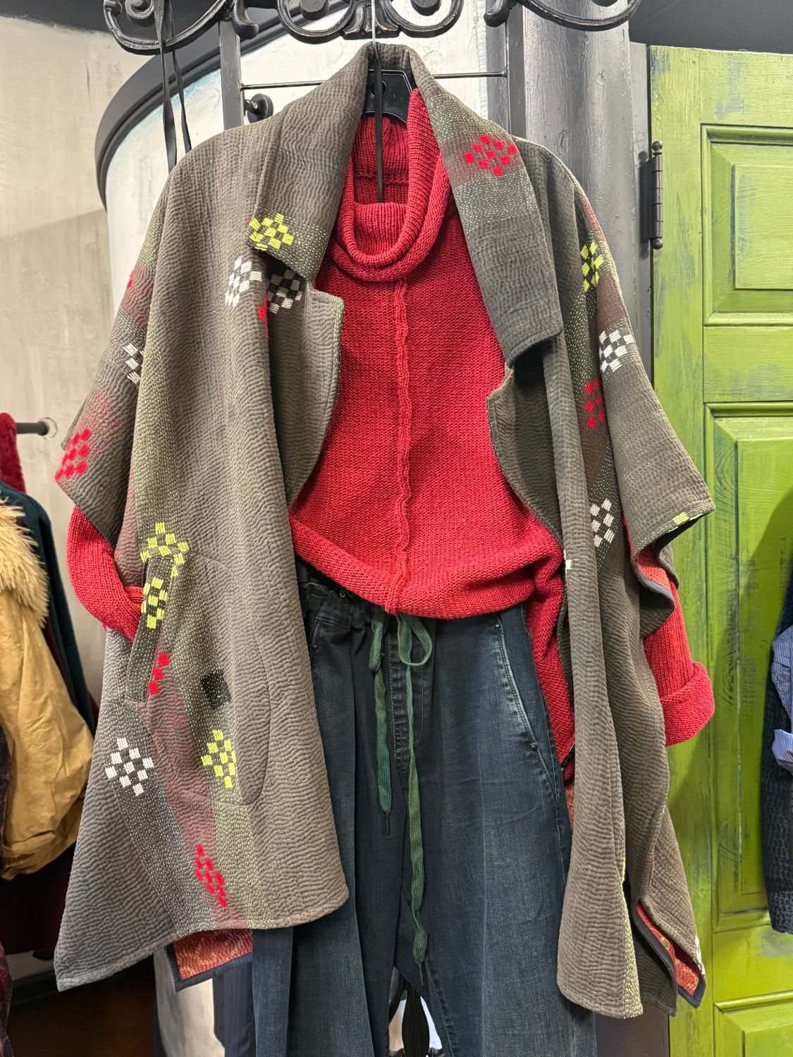 A layered look at Gaia: kantha-stitched wrap over a red knit and denim